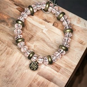 Clear pink & gold beaded bracelet with small gold charm